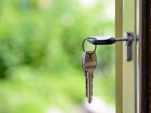 keys hanging in door lock with the fresh outdoors in the background